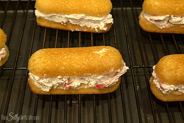 Top with the other half of the twinkie and try and clean around the edges any excess whipped topping and try to make sure the strawberry slices aren't poking out the side. Place these in the freezer for about 20 minutes to set up. 