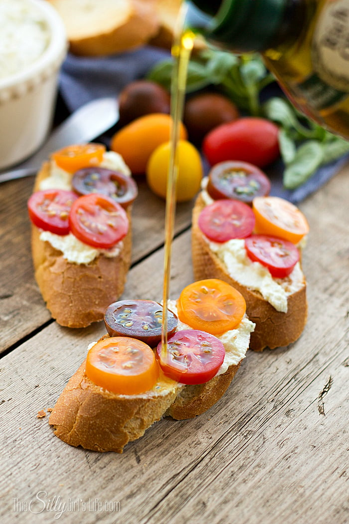 Creamy Goat Cheese Bruschetta, goat cheese and cottage cheese blended together, smeared on toasted baguette and topped with tomatoes, a yummy app or side dish! - ThisSillyGirlsLife.com #bruschetta #goatcheese